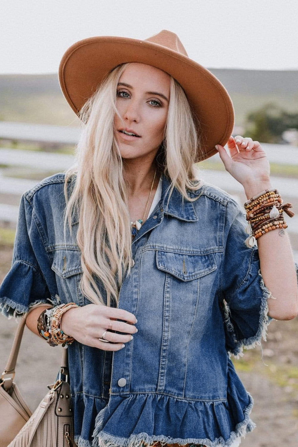 Close-up of the bell sleeves on the peacock blue denim jacket.