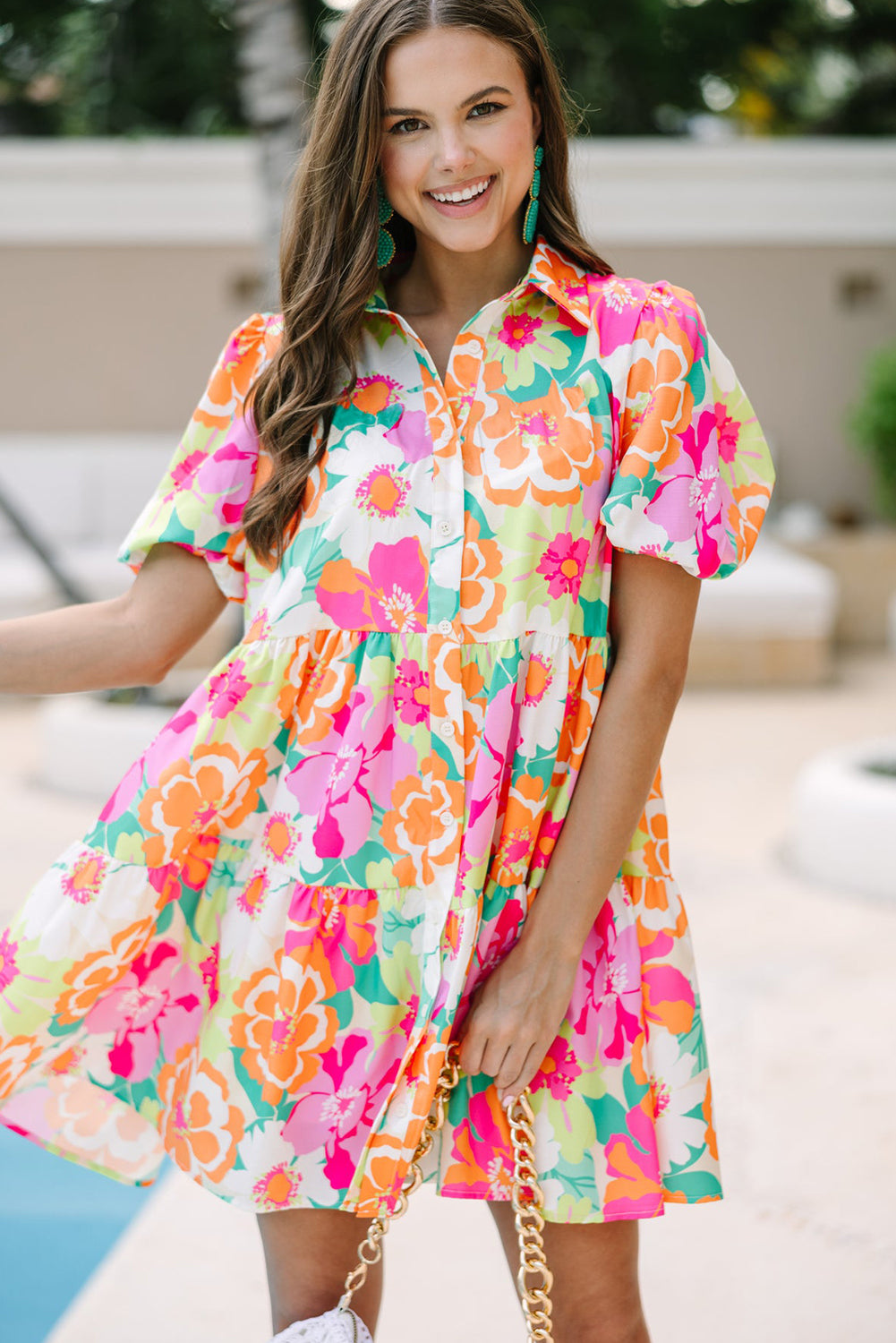 The green color and floral print of the dress are perfect for warm weather (close-up).