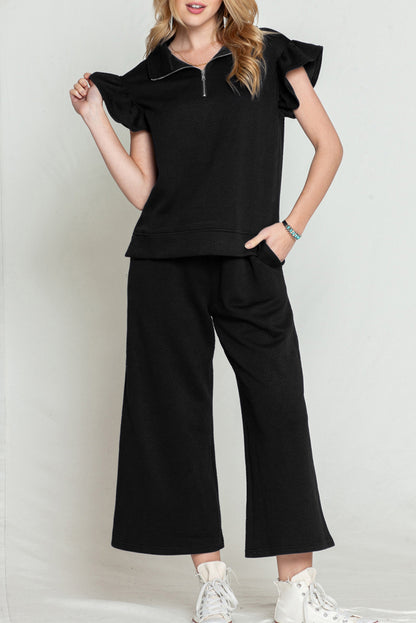 Black textured ruffle cap sleeve top and wide-leg pants set styled for a night out.