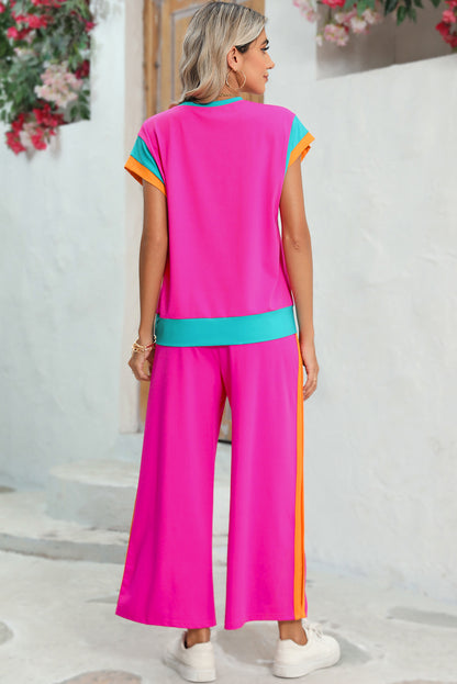 Model wearing a strawberry pink colorblock cap-sleeve tee and wide-leg pants set, showcasing the stylish and comfortable look (front view).