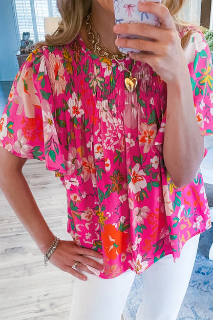 Pink floral print blouse with flounce sleeves and a smocked bodice (women's top).