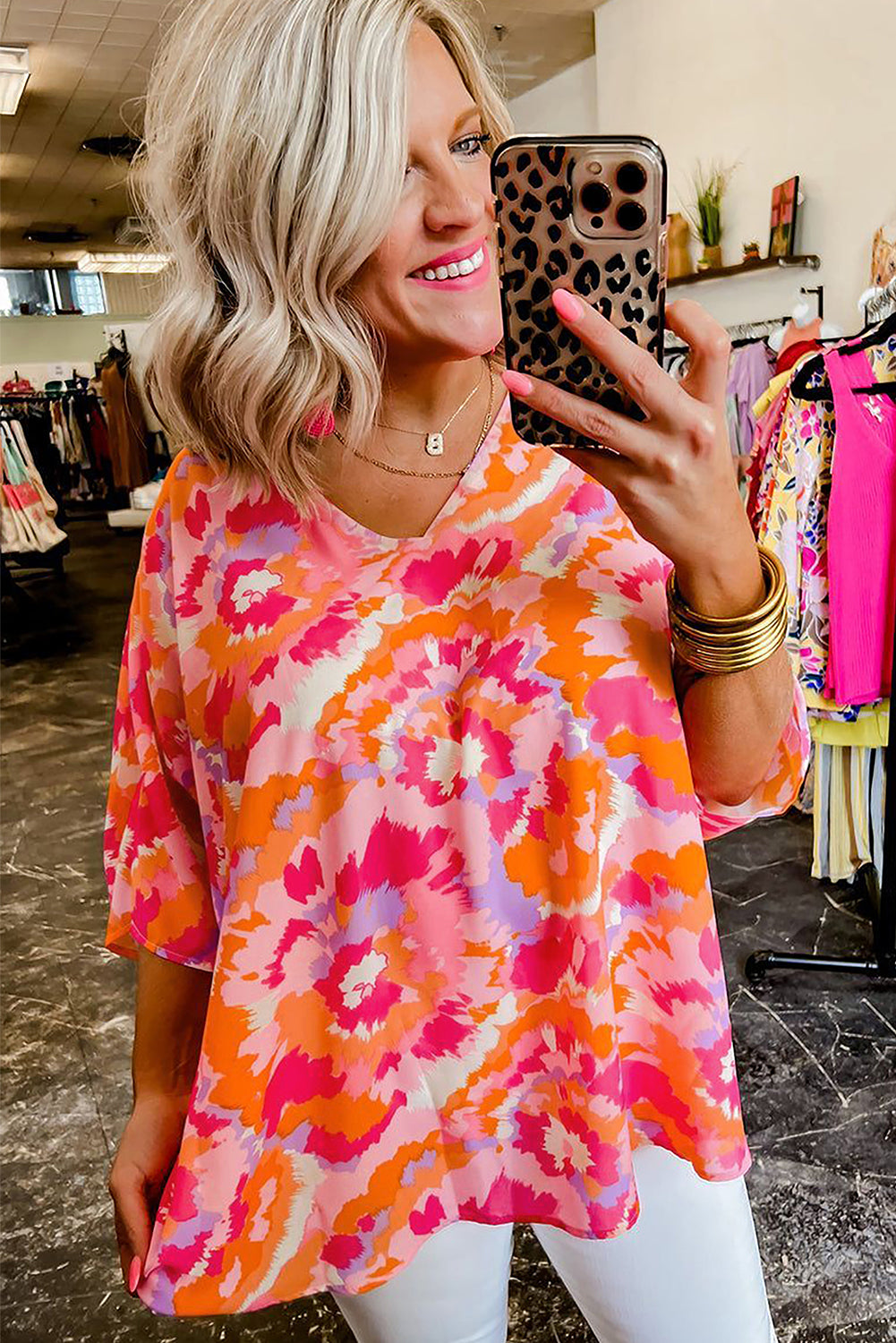 Model wearing the rose red boho top with abstract print, showcasing the V-neckline and relaxed silhouette (front view).