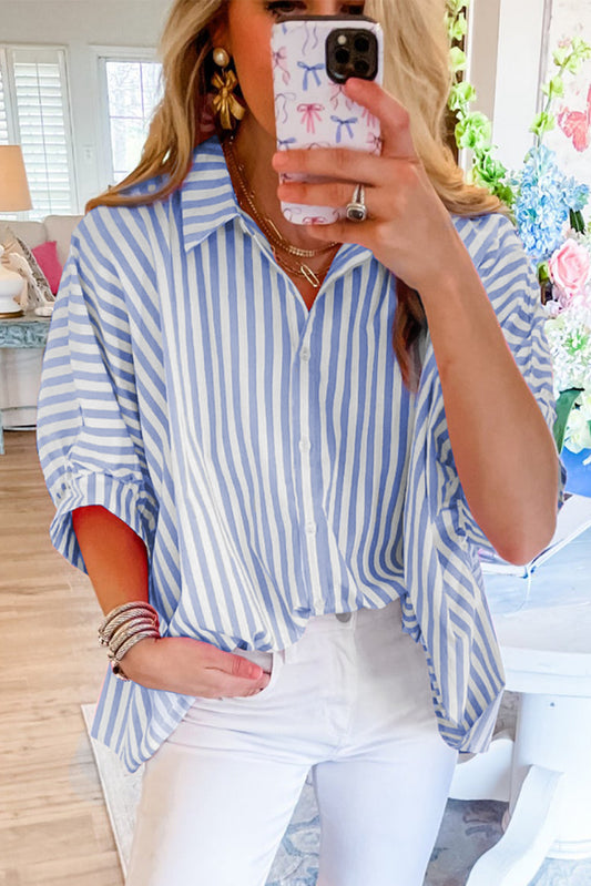 Close-up of the sky blue and white striped pattern on the fabric of the blouse.