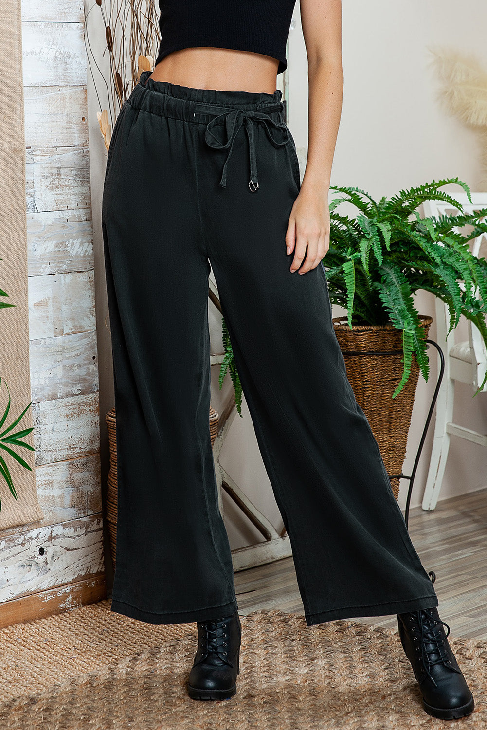 Black high-waisted wide-leg pants neatly folded for easy storage.