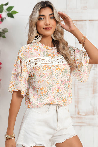 Close-up of the wide, statement-making ruffle sleeves on the multicolor floral blouse.