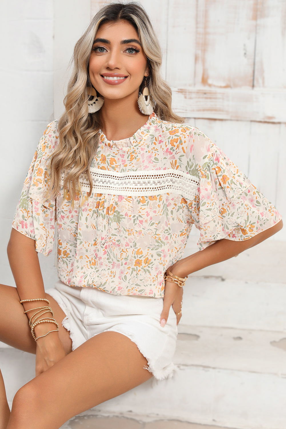 Close-up of the delicate lace splicing details on the front of the multicolor floral blouse.