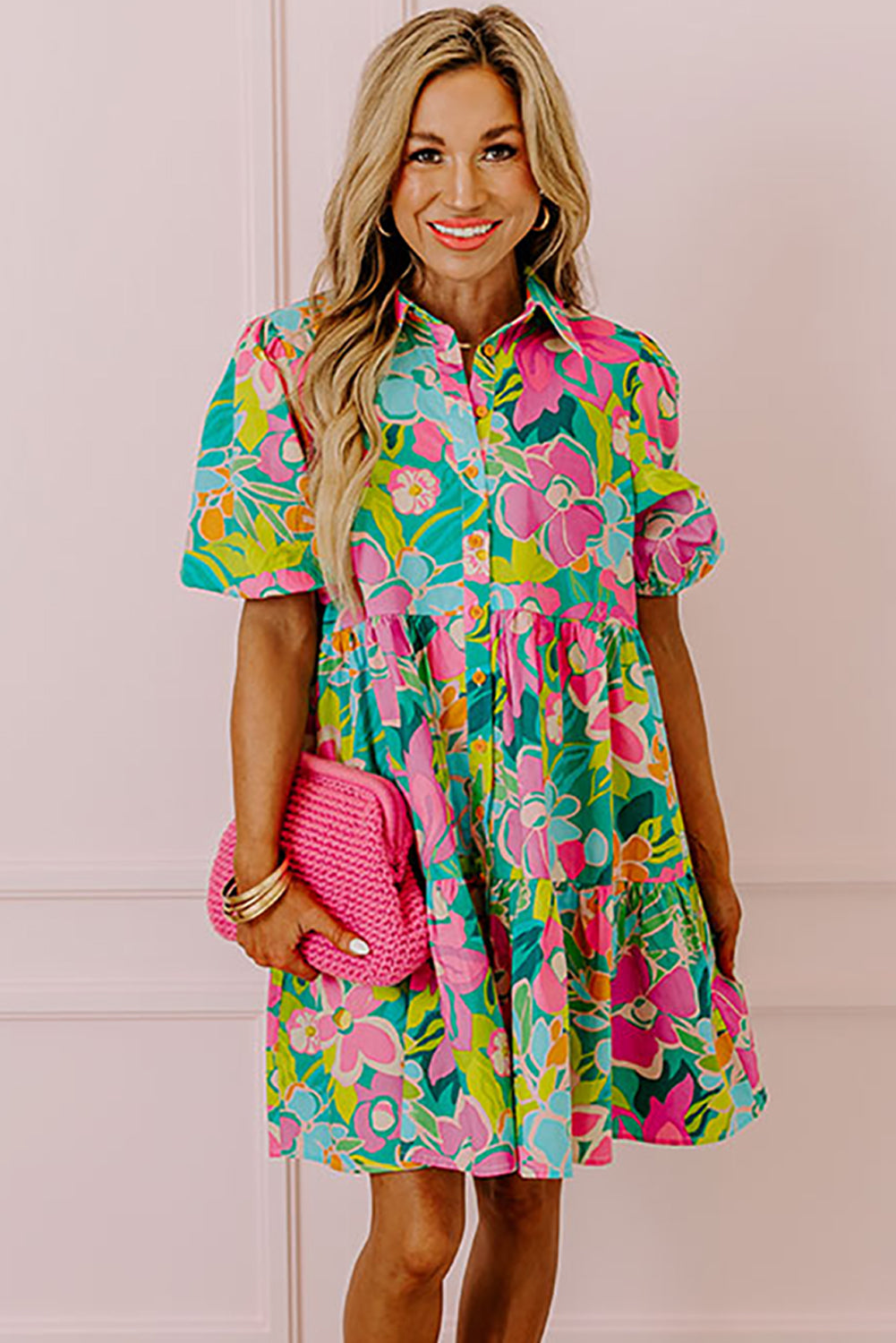 Model walking confidently in a green floral puff sleeve buttoned babydoll dress.