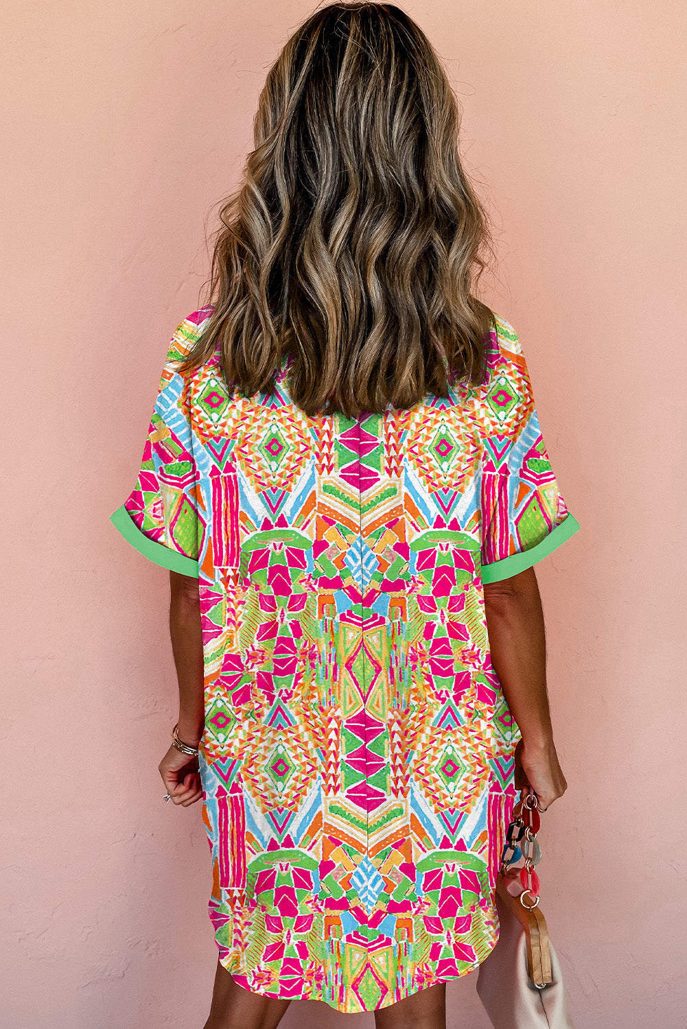 Close-up of the vibrant orange geometric print on the shirt dress.